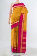 Yellow Kanjivaram Silk Saree with Zari Butta on the body and Silk Border.  displayed on a mannequin