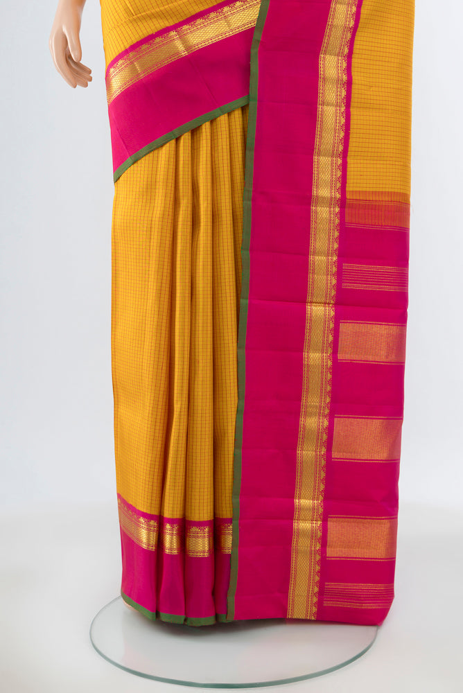 Pleats and pallu of Yellow Kanjivaram Silk Saree with Zari Butta on the body and Silk Border. 