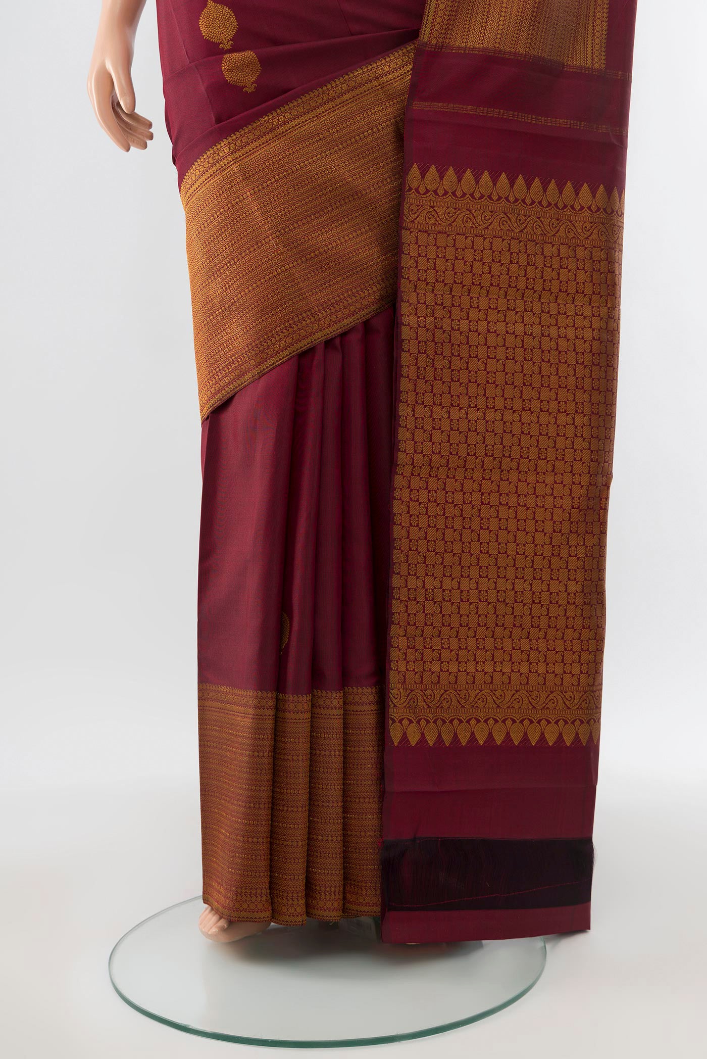 Pleats and pallu of Pure Silk Pure Zari Maroon Kanjivaram Saree with Zari Butta on the body and Silk Border. 