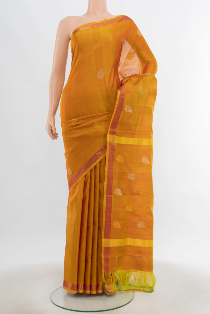 Mustard Uppada Silk Saree with Zari Butta on the body and Fancy Border.  displayed on a mannequin