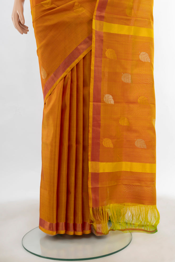 Pleats and pallu of Mustard Uppada Silk Saree with Zari Butta on the body and Fancy Border. 