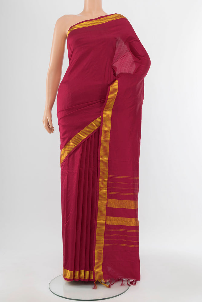 Maroon Kanjivaram Silk Saree with Zari Butta on the body and Silk Border.  displayed on a mannequin
