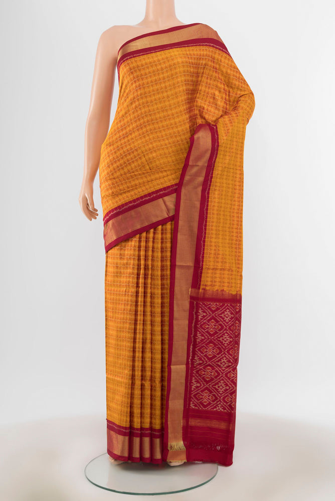 Mustard Pochampally Saree with Ikat Print on the body and Silk Border.  displayed on a mannequin