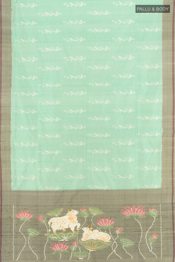 Flat view of Pista Green Pochampally Saree with Ikat Print on the body and Silk Border. 