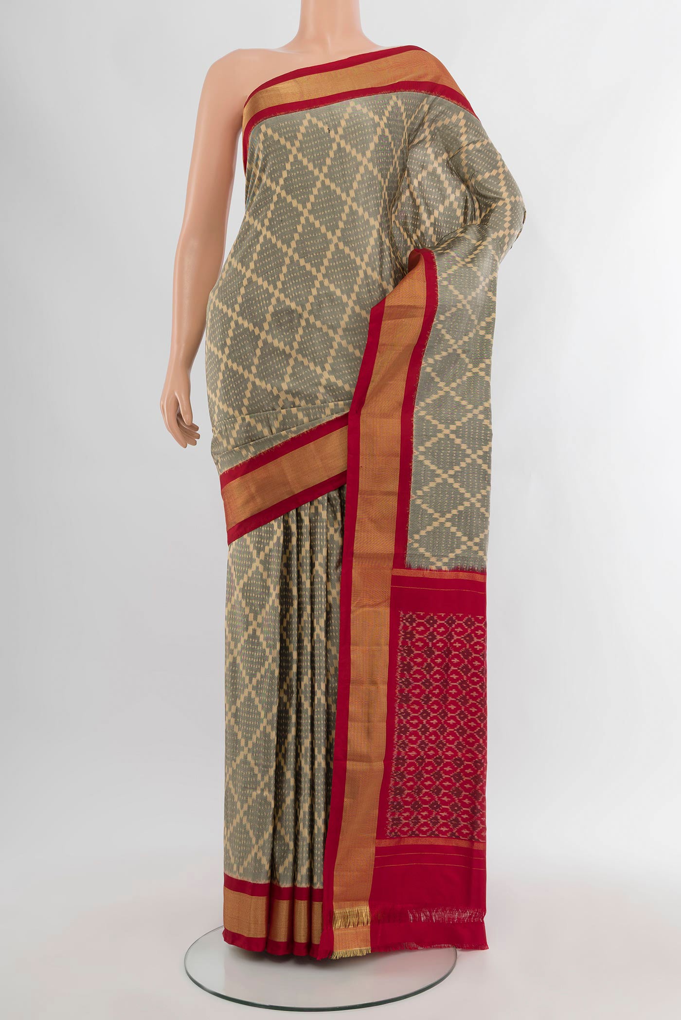 Grey Pochampally Silk Saree with Ikat design on the body and Zari Border.  displayed on a mannequin