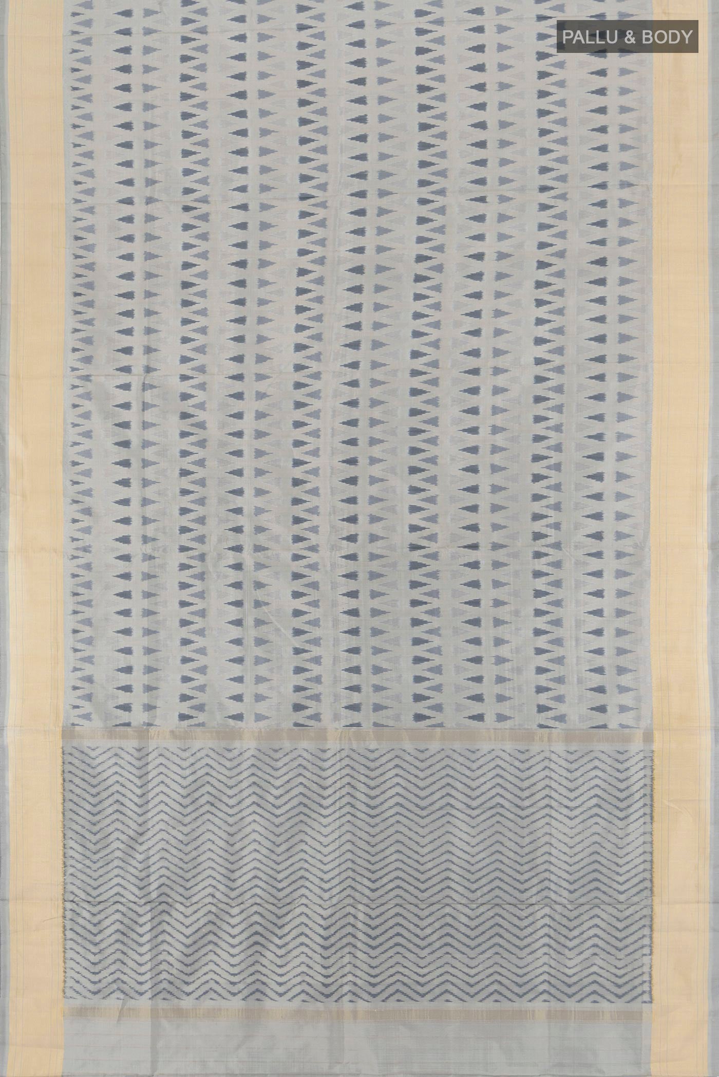 Flat view of Davys Grey Pochampally Silk Saree with Ikat design on the body and Zari Border. 