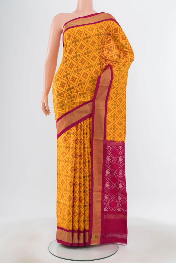 Pure Silk Pure Zari Yellow Pochampally Saree with Ikat Print on the body and Silk Border.  displayed on a mannequin