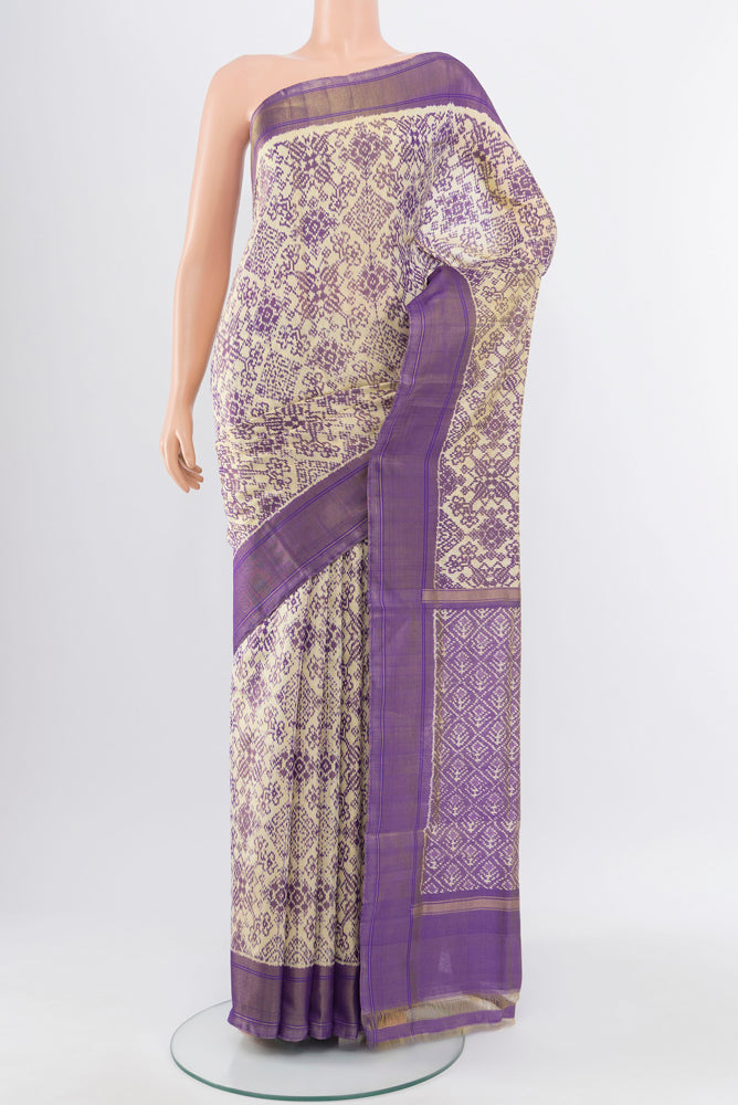 Golden Pochampally Saree with Ikat Print on the body and Silk Border.  displayed on a mannequin