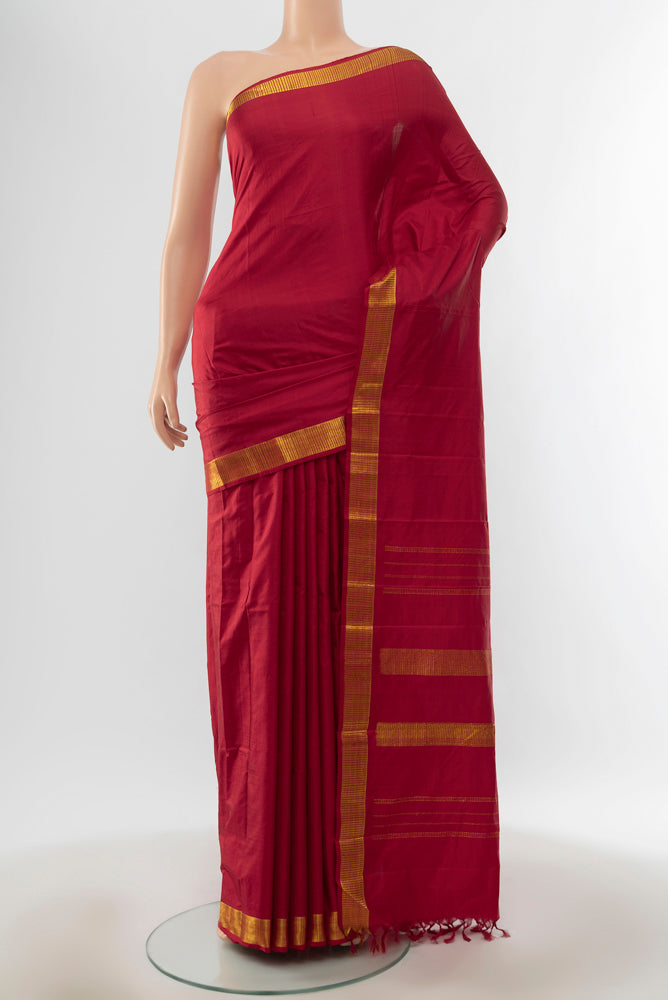 Pure Silk Pure Zari Maroon Kanjivaram Saree with Zari Butta on the body and Silk Border.  displayed on a mannequin