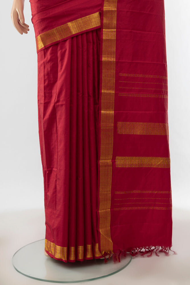 Pleats and pallu of Pure Silk Pure Zari Maroon Kanjivaram Saree with Zari Butta on the body and Silk Border. 