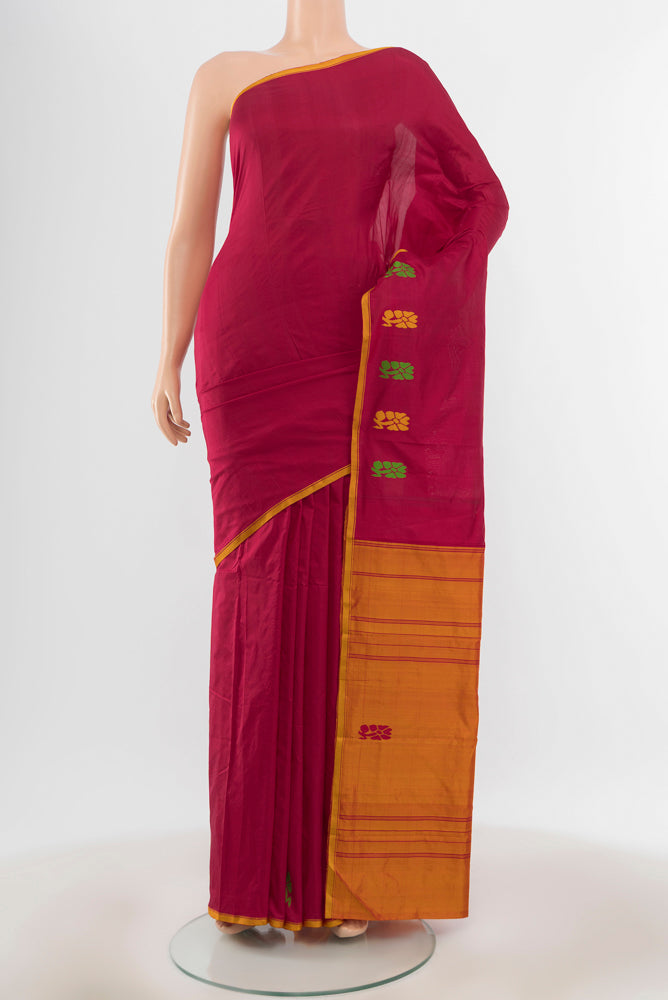 Pure Silk Pure Zari Maroon Kanchipuram Saree with Zari Butta on the body and Silk Border.  displayed on a mannequin