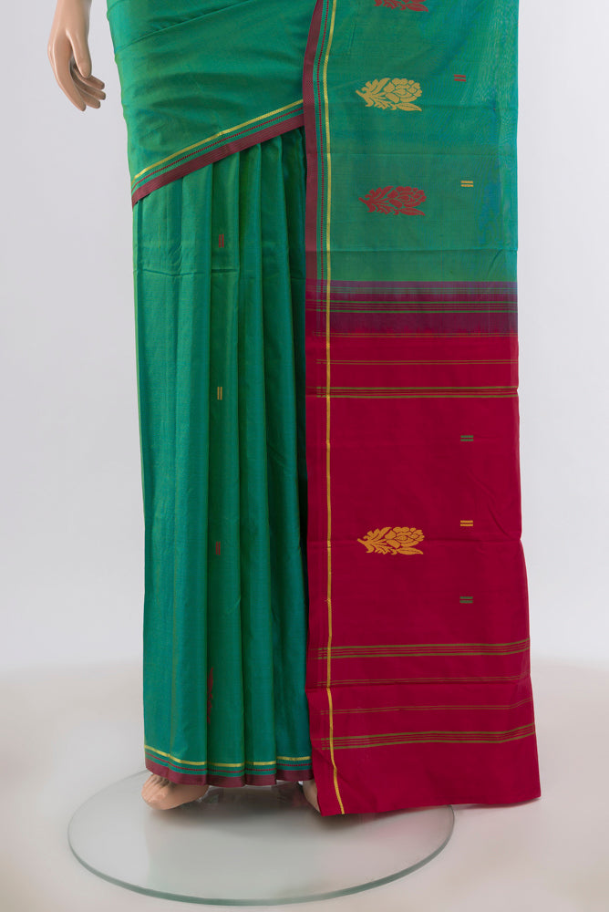 Pleats and pallu of Peacock Blue Kanchipuram Silk Saree with Zari Butta on the body and Silk Border. 