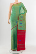 Light Green Kanchipuram Silk Saree with Zari Butta on the body and Silk Border.  displayed on a mannequin