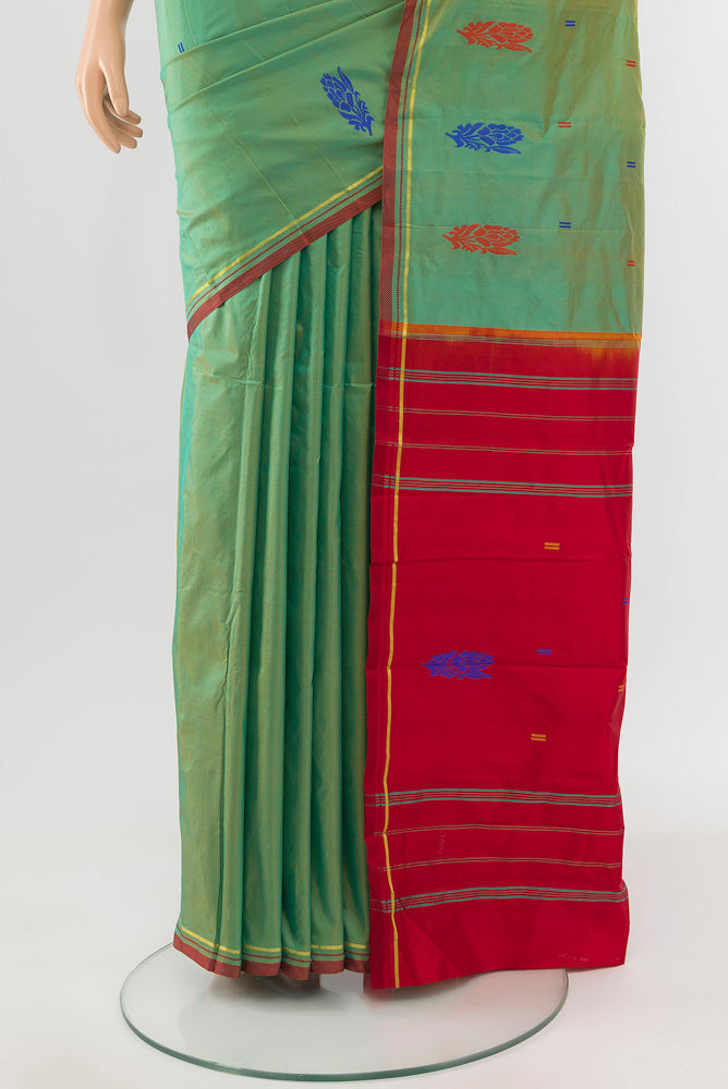 Pleats and pallu of Light Green Kanchipuram Silk Saree with Zari Butta on the body and Silk Border. 