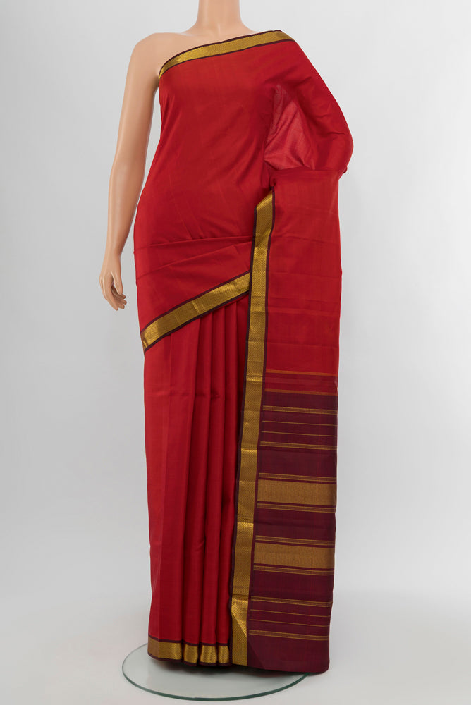 Red Kanjivaram Silk Saree with Zari Butta on the body and Silk Border.  displayed on a mannequin