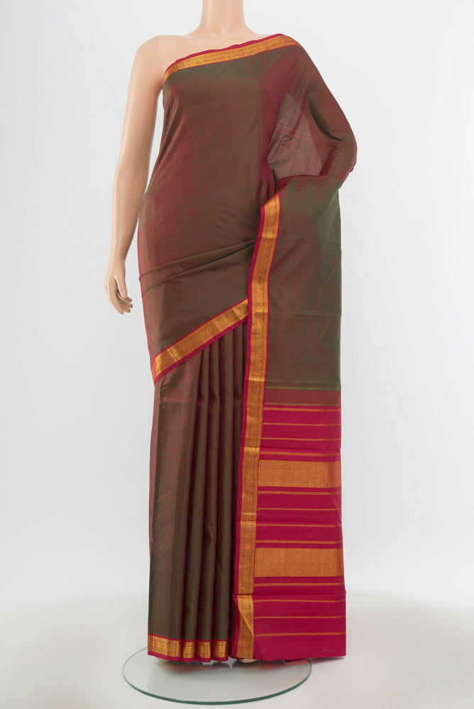 Pure Silk Pure Zari Mehandi Green Kanjivaram Saree with Zari Butta on the body and Silk Border.  displayed on a mannequin