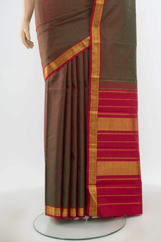 Pleats and pallu of Pure Silk Pure Zari Mehandi Green Kanjivaram Saree with Zari Butta on the body and Silk Border. 