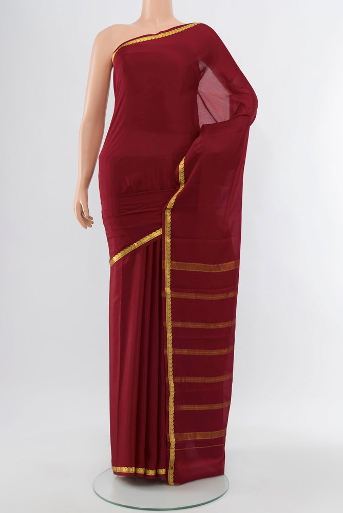 Maroon Mysore Crepe Saree with Zari Butta on the body and Silk Border.  displayed on a mannequin