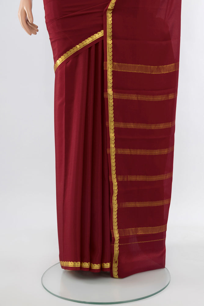 Pleats and pallu of Maroon Mysore Crepe Saree with Zari Butta on the body and Silk Border. 