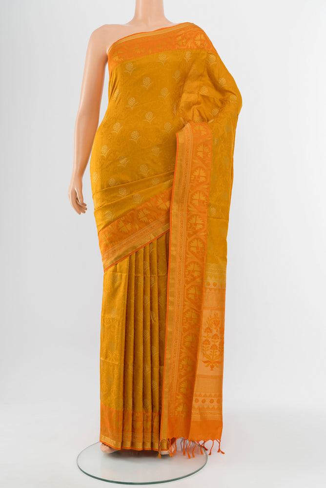 Mustard Soft Silk Saree with Zari Butta on the body and Silk Border.  displayed on a mannequin