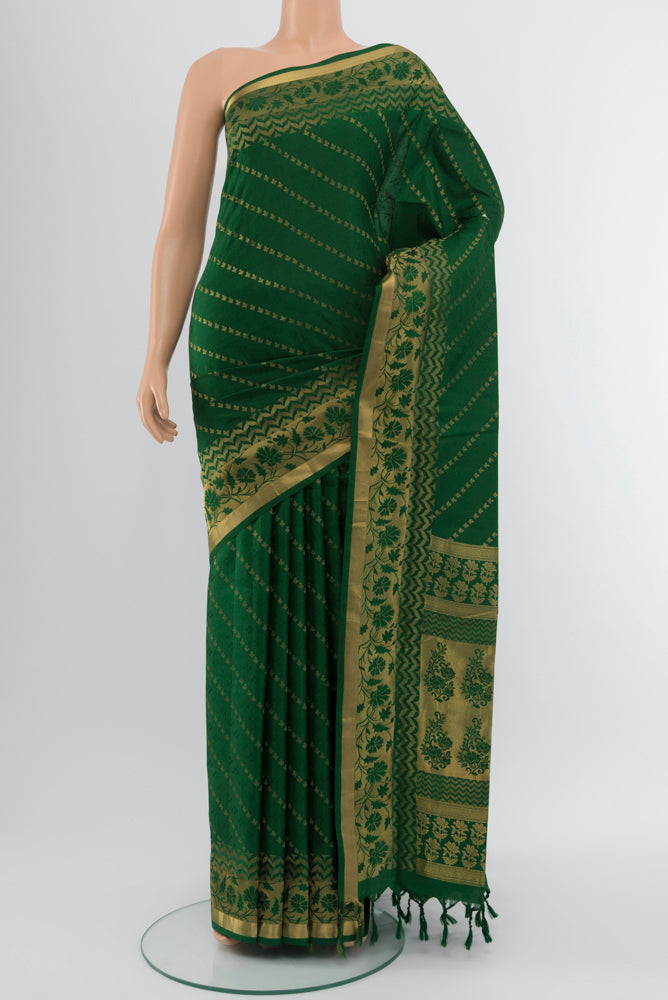 Bottle Green Soft Silk Saree with Zari Butta on the body and Silk Border.  displayed on a mannequin