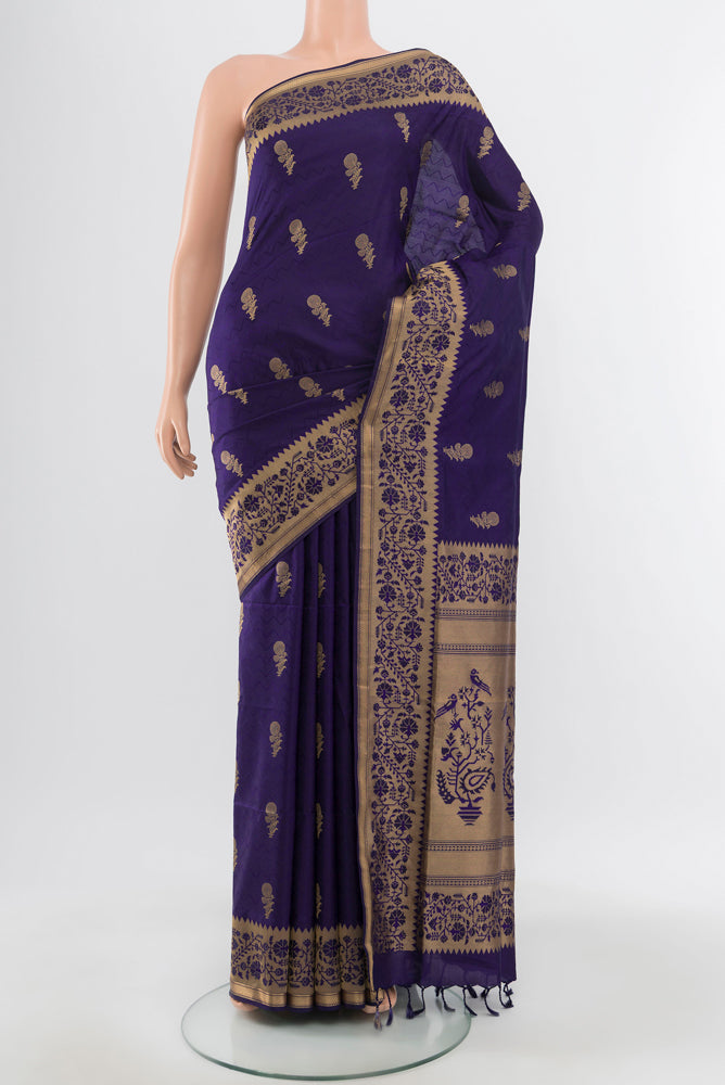 Pure Silk Pure Zari Navy Blue Soft Saree with Zari Butta on the body and Silk Border.  displayed on a mannequin
