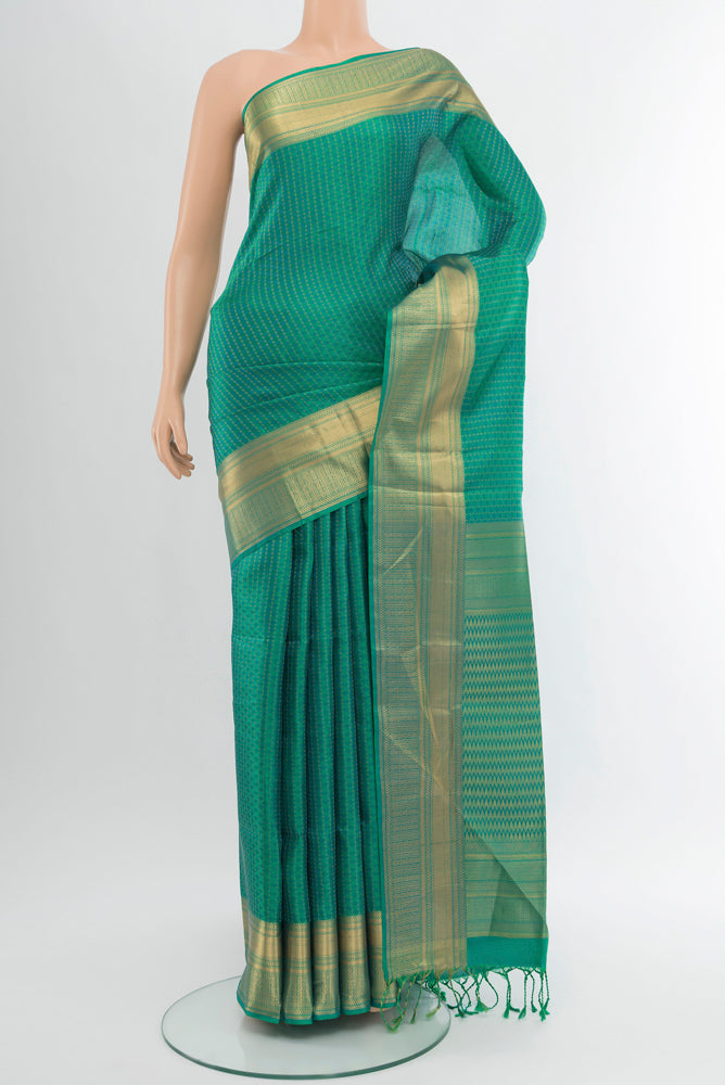 Pure Silk Pure Zari Light Green Soft Saree with Zari Butta on the body and Silk Border.  displayed on a mannequin