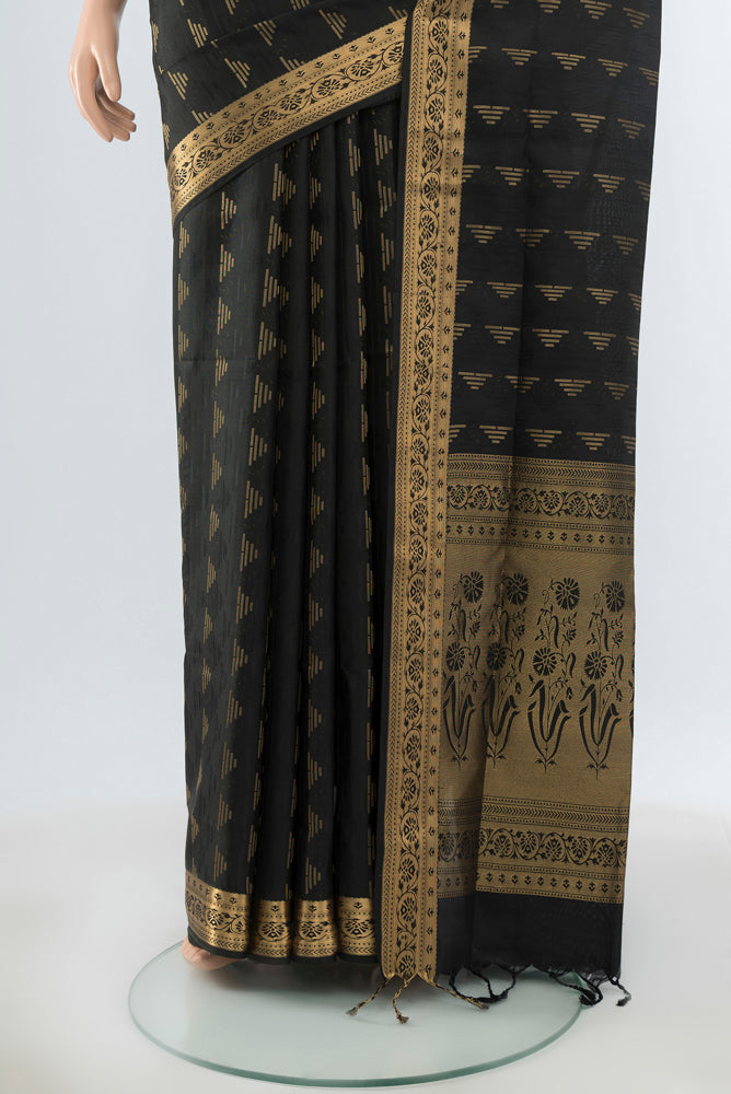 Pleats and pallu of Black Soft Silk Saree with Zari Butta on the body and Silk Border. 
