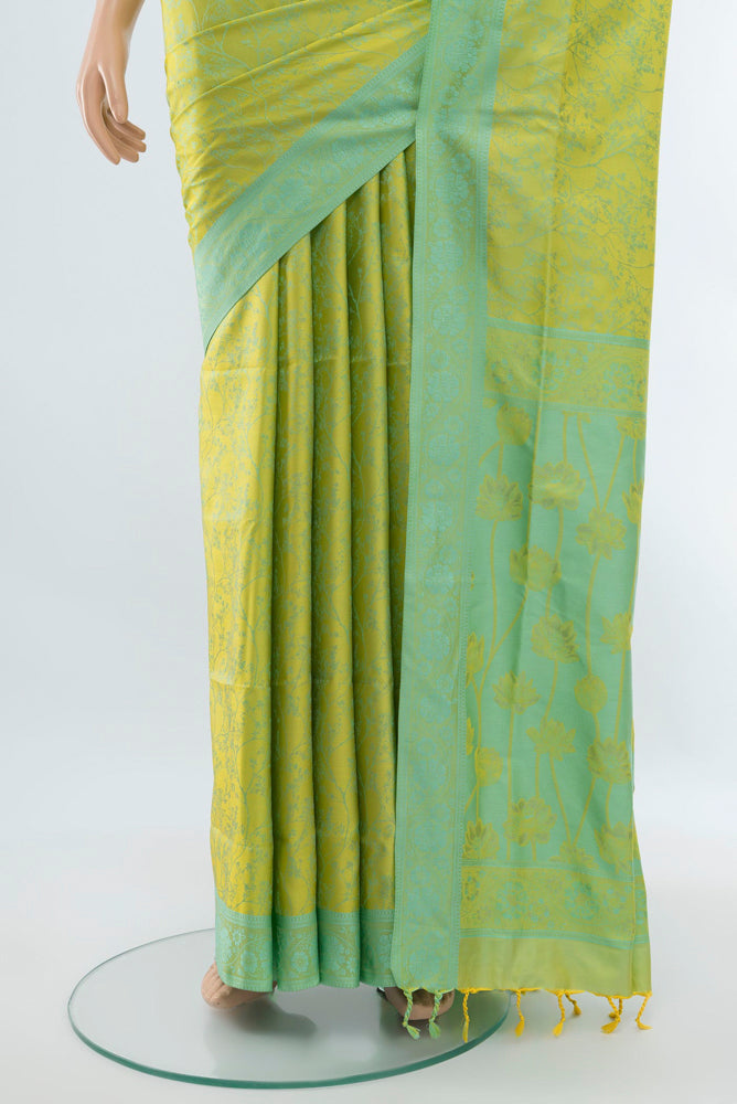 Pleats and pallu of Light Green Soft Silk Saree with Zari Butta on the body and Silk Border. 