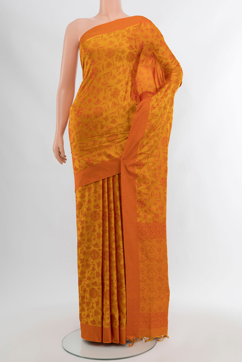 Mustard Soft Silk Saree with Thread Butta on the body and Silk Border.  displayed on a mannequin