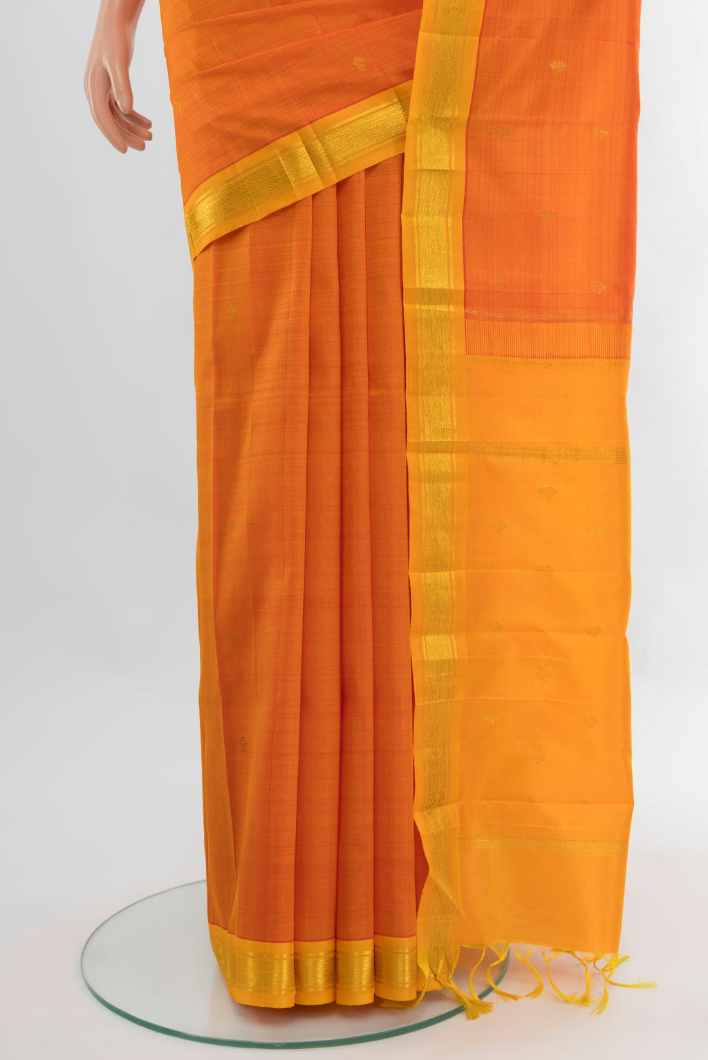 Pleats and pallu of Orange Kanjivaram Silk Saree with Zari Butta on the body and One Side Border. 