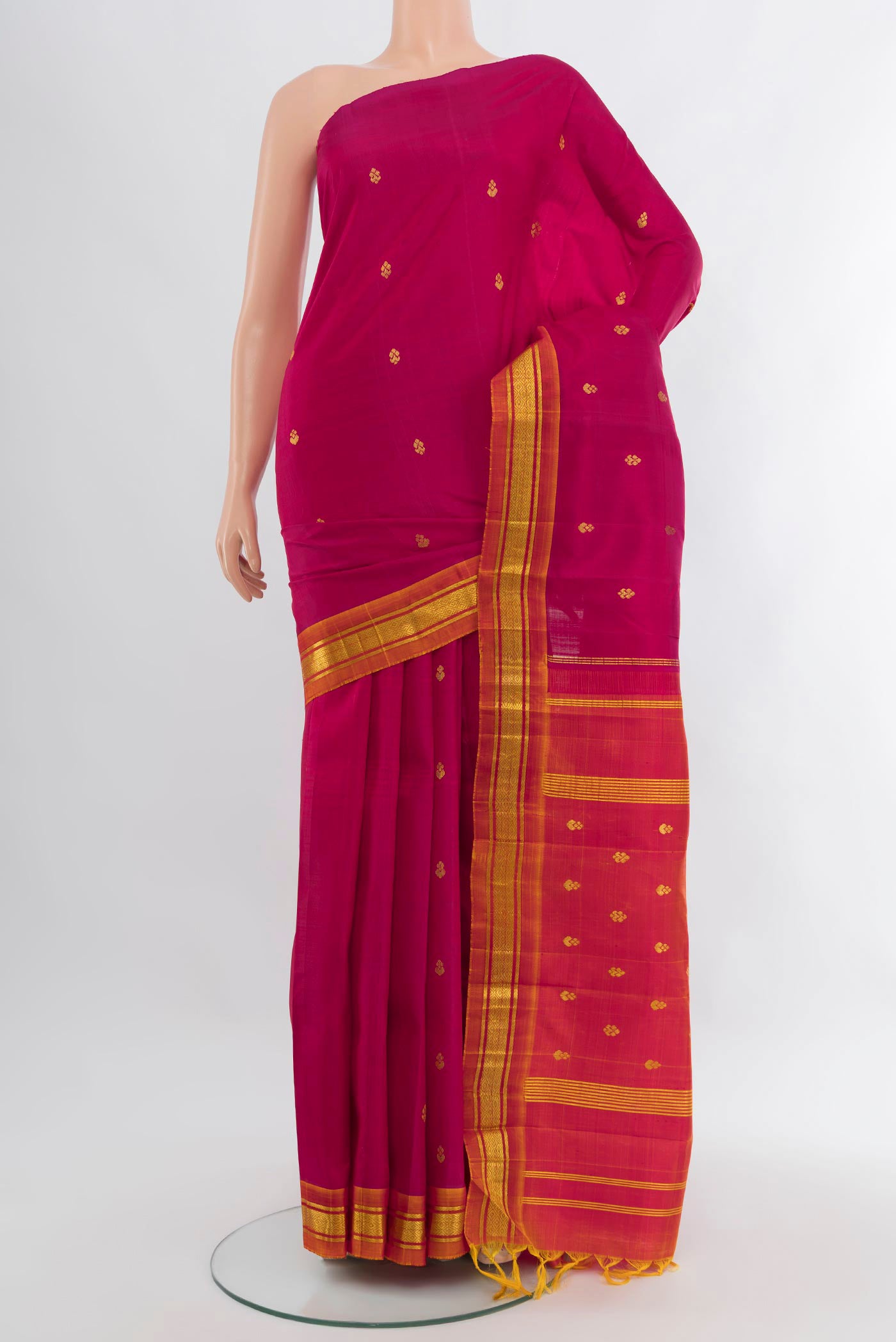 Dark Pink Kanjivaram Silk Saree with Zari Butta on the body and One Side Border.  displayed on a mannequin