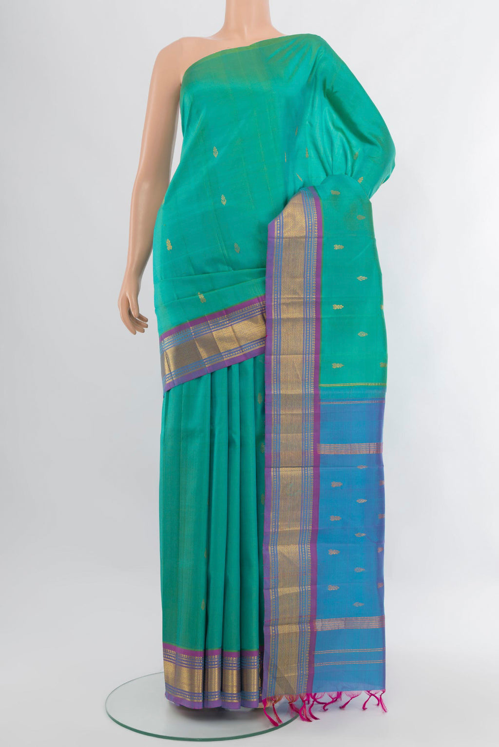 Turquoise Kanjivaram Silk Saree with Zari Butta on the body and One Side Border.  displayed on a mannequin