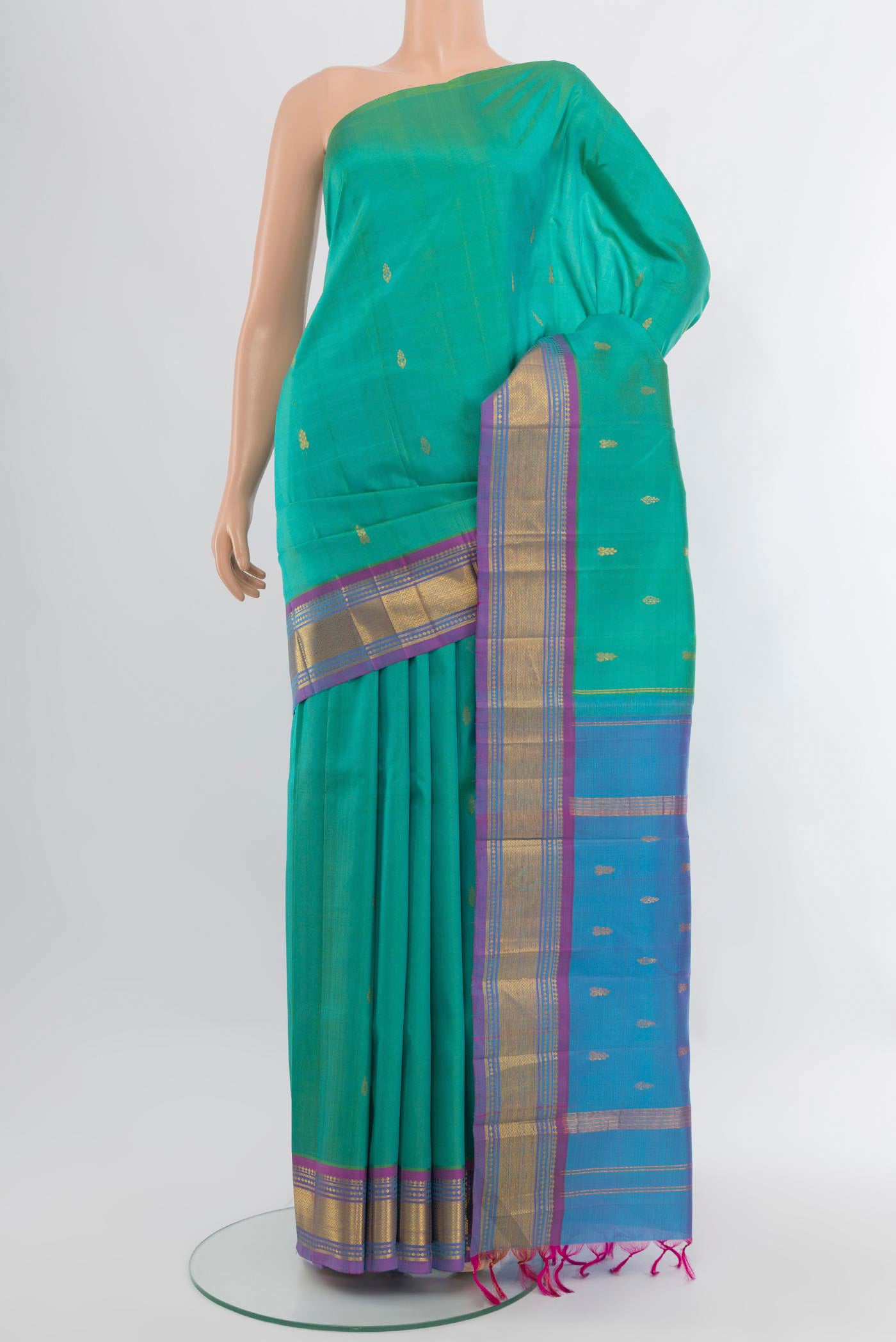 Turquoise Kanjivaram Silk Saree with Zari Butta on the body and One Side Border.  displayed on a mannequin