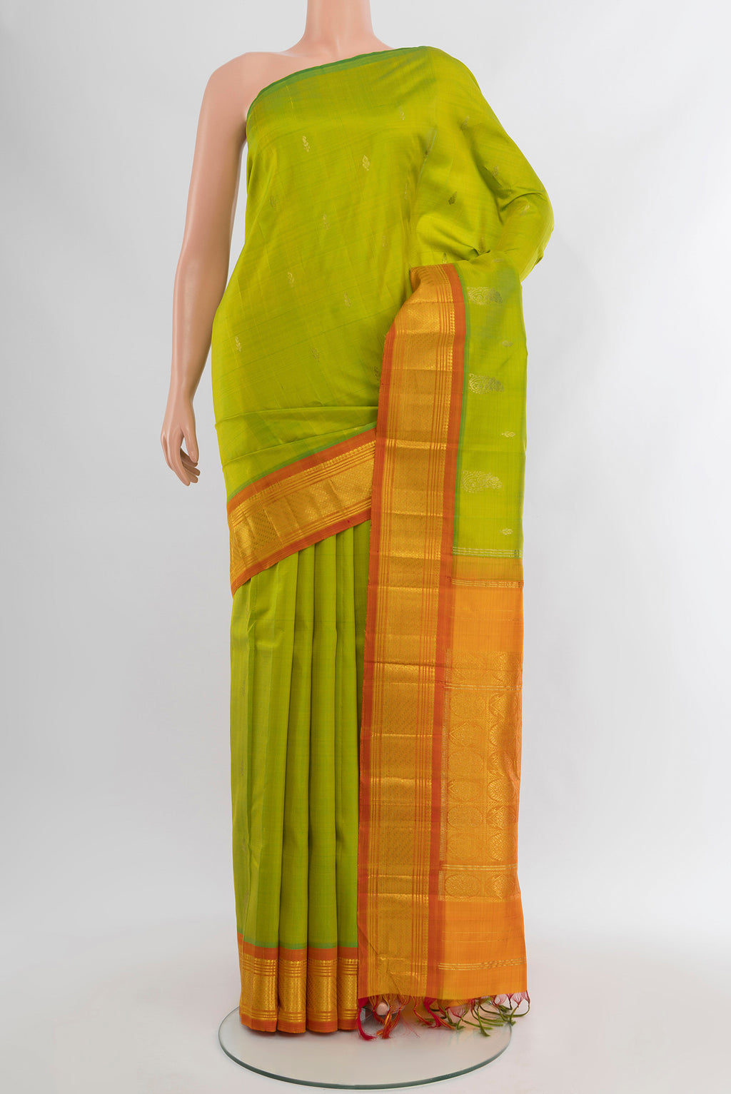 Parrot Green Kanchipuram Silk Saree with Zari Butta on the body and One Side Border.  displayed on a mannequin