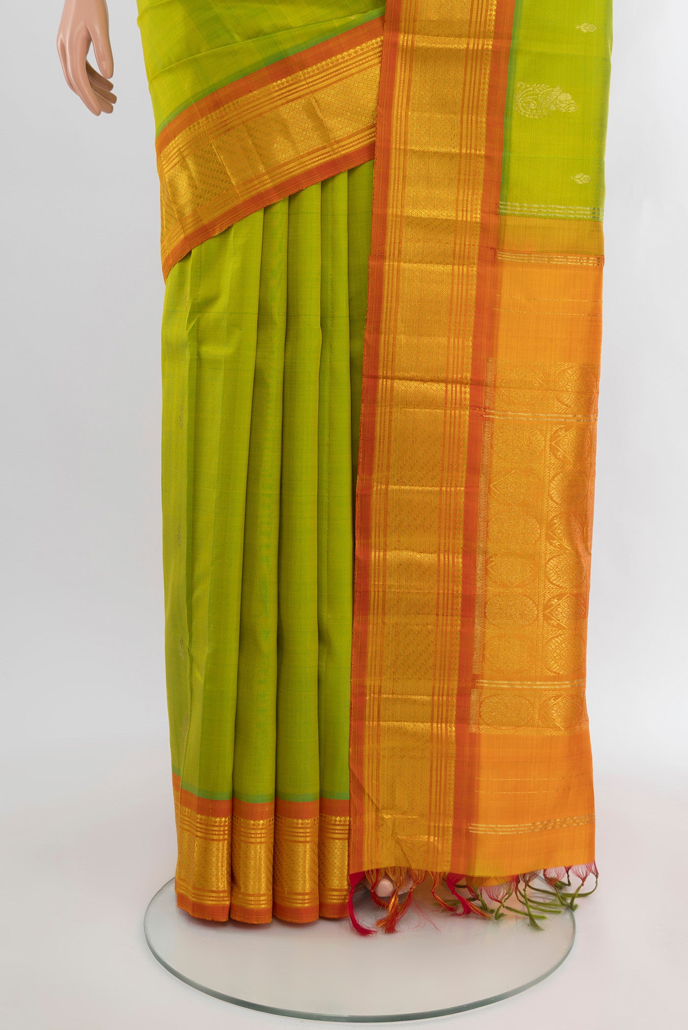 Pleats and pallu of Parrot Green Kanchipuram Silk Saree with Zari Butta on the body and One Side Border. 