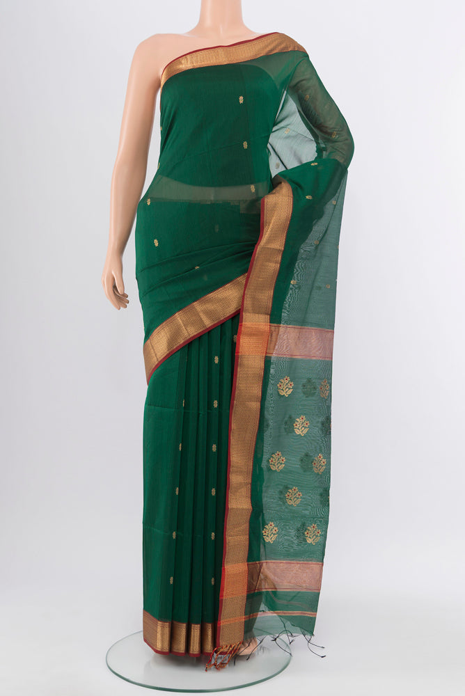 Bottle Green Maheshwari Silk Cotton Saree with Zari Butta on the body and Silk Border.  displayed on a mannequin