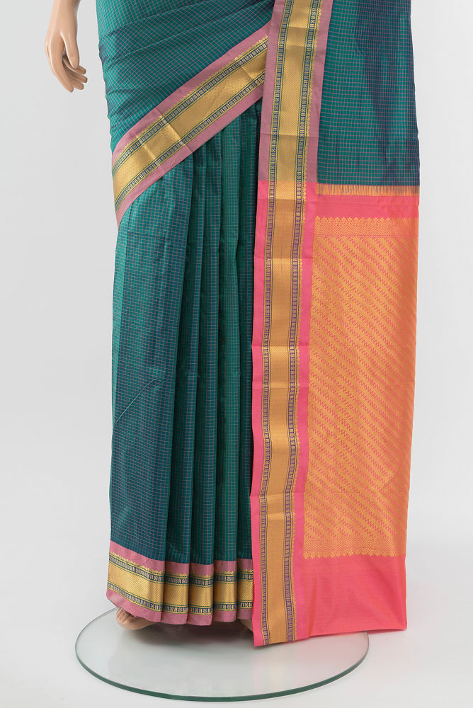 Pleats and pallu of Peacock Blue Narayanpet Silk Saree with Zari Butta on the body and Silk Border. 