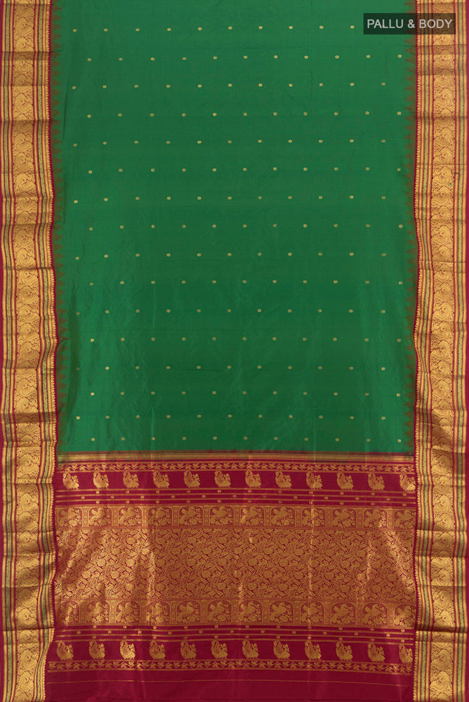 Flat view of Bottle Green Pochampally Saree with Zari Butta on the body and Silk Border. 