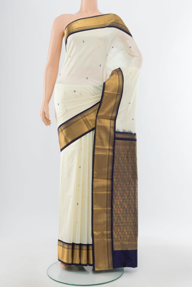 Cream Narayanpet Silk Saree with Zari Butta on the body and Silk Border.  displayed on a mannequin