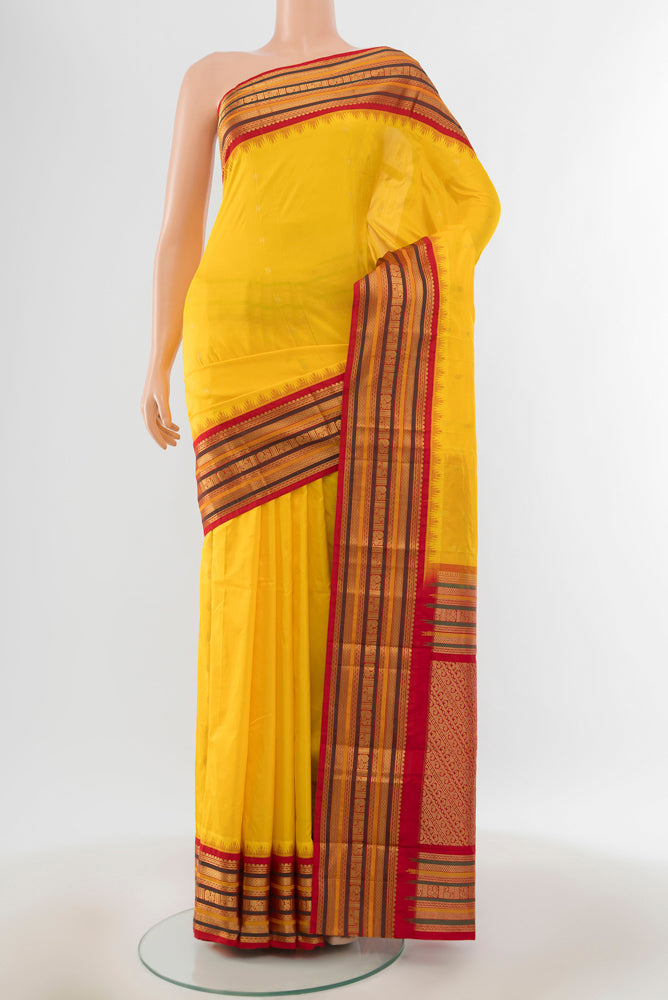 Yellow Bangalore Silk Saree with Zari Butta on the body and Silk Border.  displayed on a mannequin