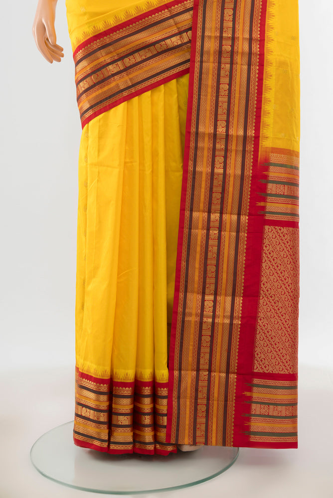 Pleats and pallu of Yellow Bangalore Silk Saree with Zari Butta on the body and Silk Border. 