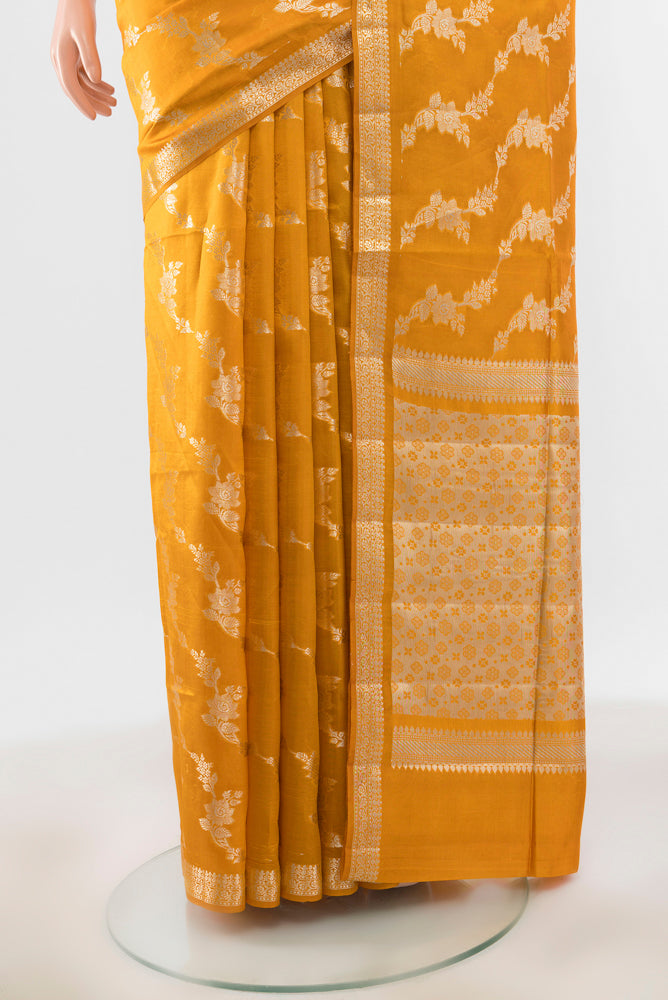 Pleats and pallu of Mustard Banarasi Raw Silk Saree with Zari Brocade on the body and Silk Border. 