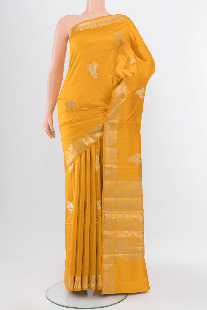 Yellow Banarasi Katan Silk Saree with Zari Butta on the body and Silk Border.  displayed on a mannequin