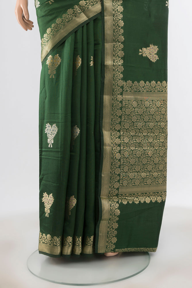 Pleats and pallu of Pure Silk Pure Zari Bottle Green Banarasi Raw Saree with Zari Butta on the body and Silk Border. 