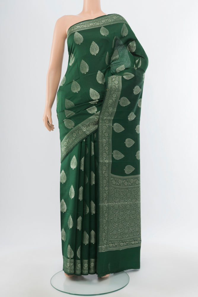 Mint Green Banarasi Raw Silk Saree with Zari Butta on the body and Silk Border.  displayed on a mannequin