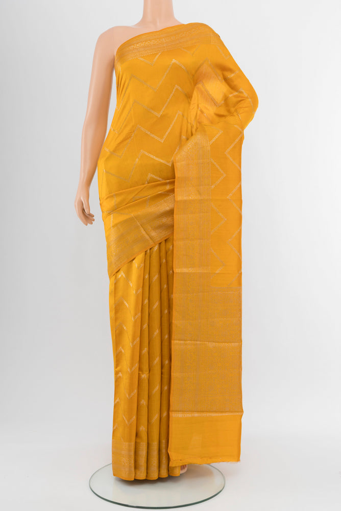 Yellow Tussar Silk Saree with Zari Brocade on the body and Silk Border.  displayed on a mannequin
