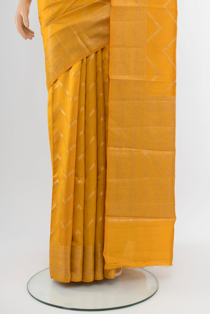 Pleats and pallu of Yellow Tussar Silk Saree with Zari Brocade on the body and Silk Border. 