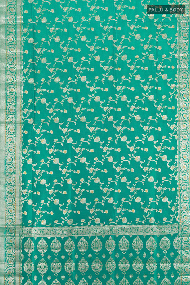 Flat view of Pure Silk Pure Zari Peacock Blue Banarasi Raw Saree with Zari Butta on the body and Silk Border. 