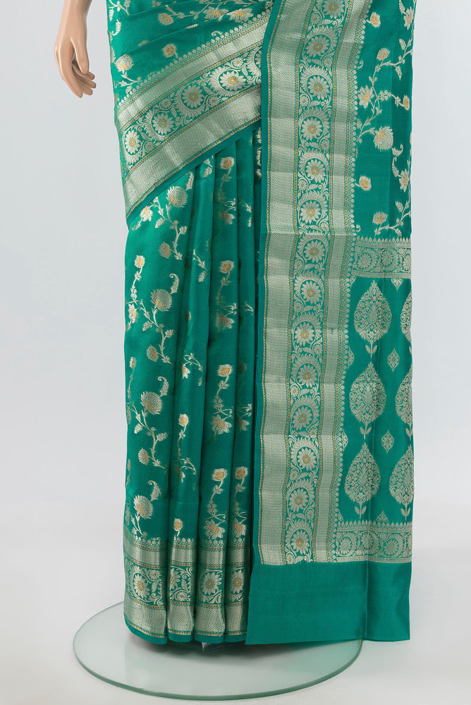 Pleats and pallu of Pure Silk Pure Zari Peacock Blue Banarasi Raw Saree with Zari Butta on the body and Silk Border. 